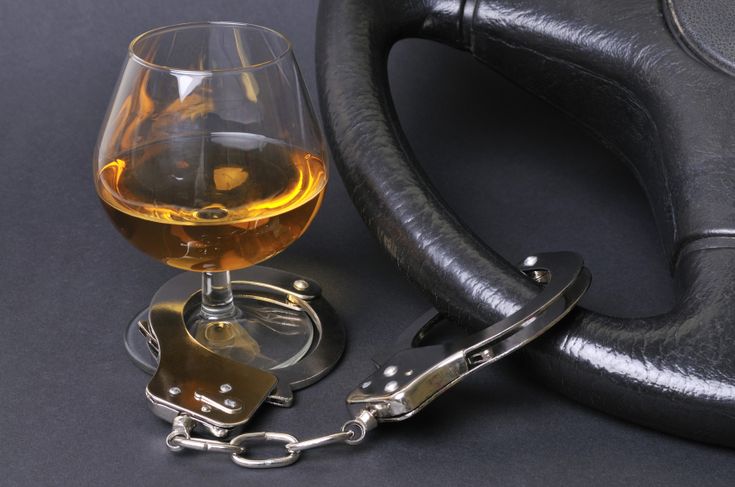 a glass of wine and handcuff